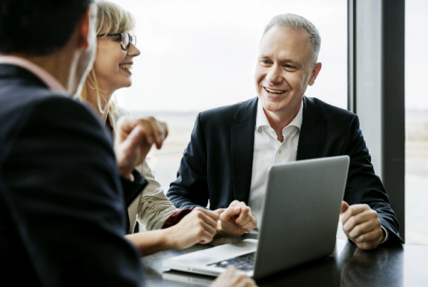 Colleagues in a meeting using lease accounting software.