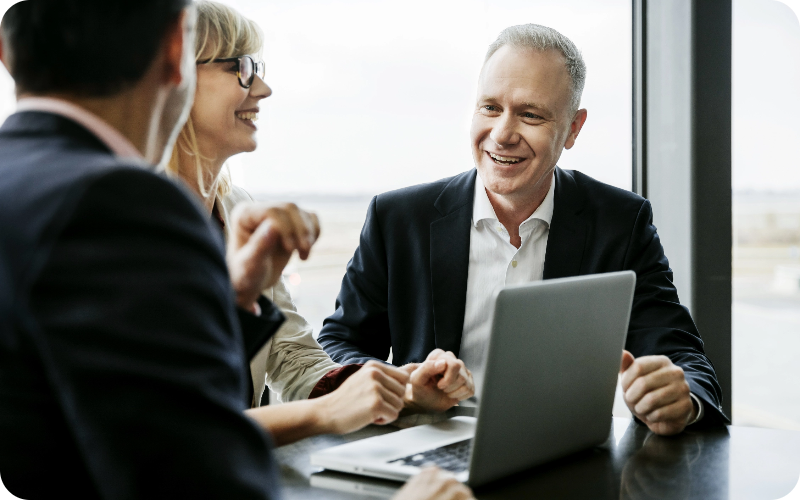 Colleagues in a meeting using lease accounting software.