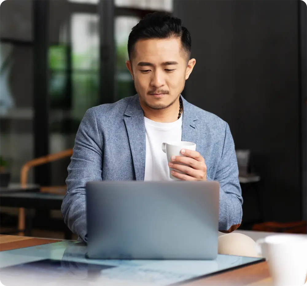 Man on a laptop using lease management software.
